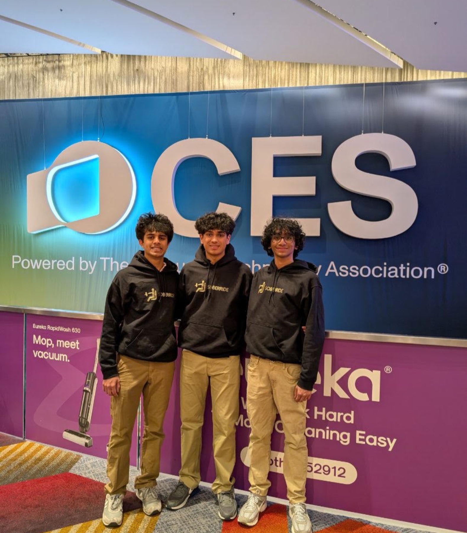 SoberRide team in branded hoodies standing in front of the CES sign